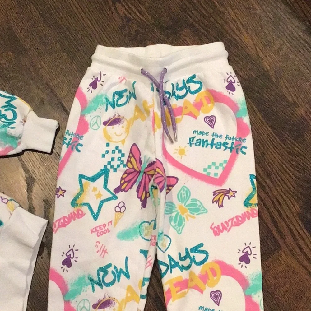 PRIMARK -children's tracksuit featuring a colorful all-over graffiti-style print